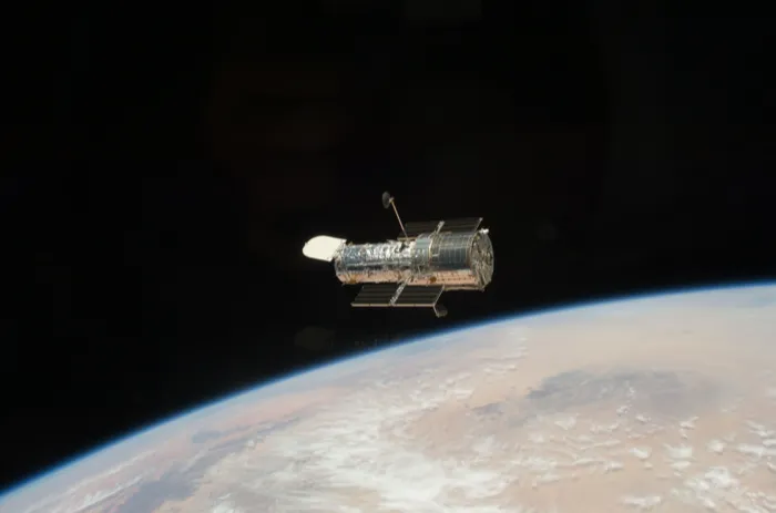 The Hubble Space Telescope drifting above the Earth's horizon after its release from Space Shuttle Atlantis in 2009.