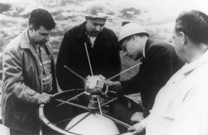 Vanguard 1, the polished 16-centimetre sphere with six antennas, being fitted to its rocket by a team of Naval Research Laboratory scientists in 1958.