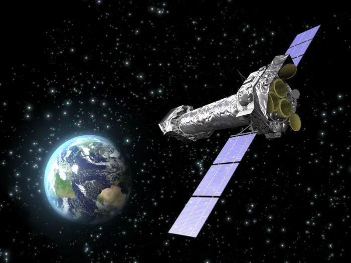 An artist’s impression of XMM-Newton in space, its three gold-rimmed X-ray mirror modules facing out and the Earth beyond.